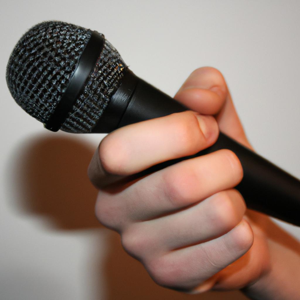 Person holding a microphone, speaking