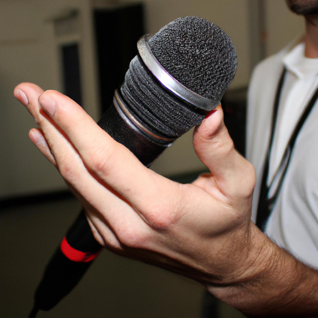 Person holding a microphone, interviewing